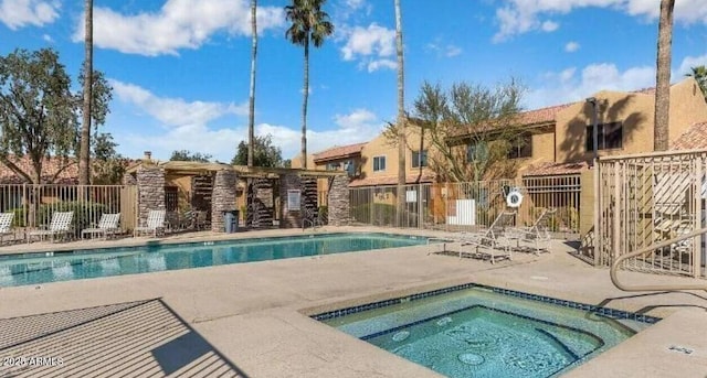 view of pool with a community hot tub and a patio