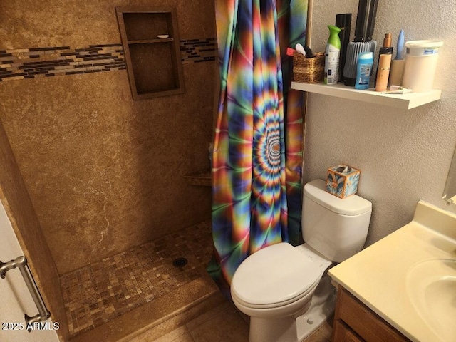 bathroom featuring toilet, vanity, and a shower with shower curtain