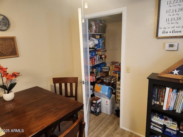 dining space with wood-type flooring