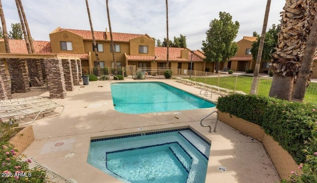 view of swimming pool featuring a patio area and a hot tub