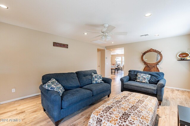 living room with ceiling fan and light hardwood / wood-style floors