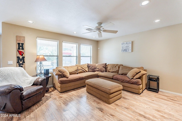 living room with light hardwood / wood-style flooring and ceiling fan