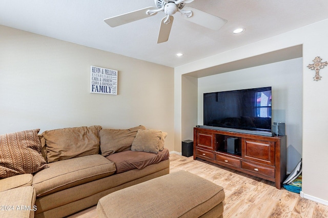 living room featuring light wood-type flooring and ceiling fan