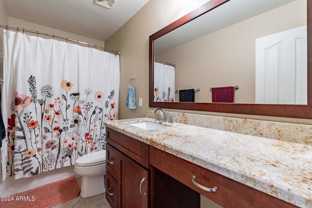 bathroom with tile patterned flooring, toilet, and vanity