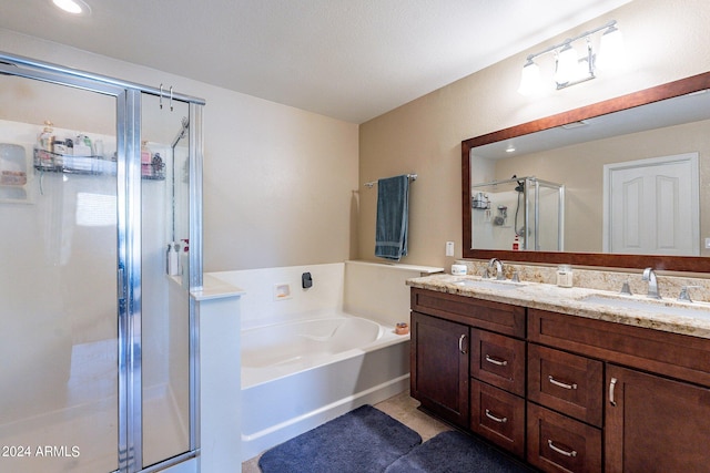 bathroom with independent shower and bath, double vanity, and tile patterned flooring