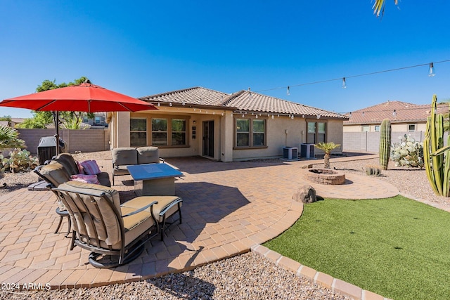 back of property featuring central air condition unit and a patio area