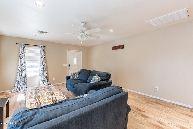 living room with ceiling fan and light hardwood / wood-style floors