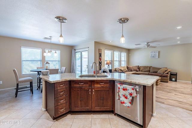 kitchen featuring stainless steel dishwasher, sink, light wood-type flooring, ceiling fan, and hanging light fixtures