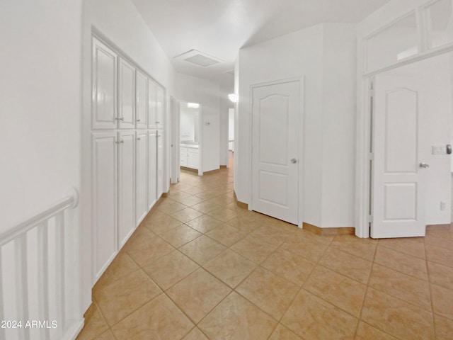 hallway featuring light tile flooring