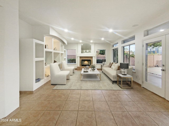 tiled living room featuring french doors and built in features