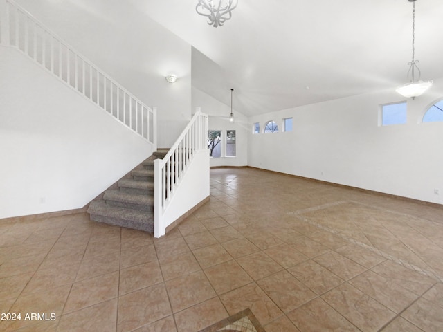 unfurnished living room with tile floors and a chandelier