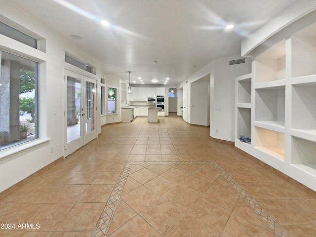 unfurnished sunroom with french doors