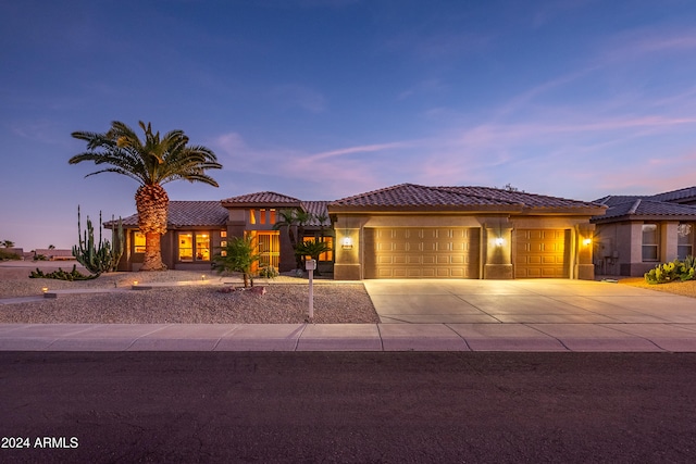 mediterranean / spanish-style home with a garage