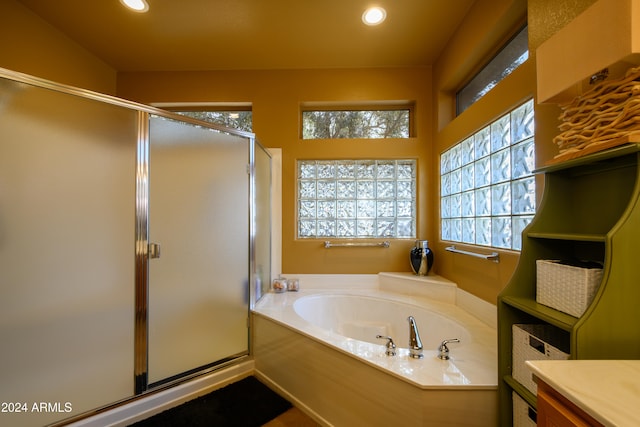 bathroom with vanity and independent shower and bath