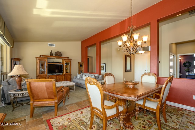 carpeted dining room with a chandelier and vaulted ceiling