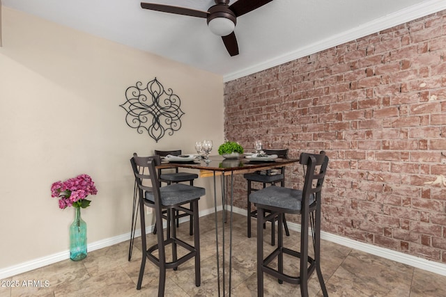 8155 E Columbus Ave, Scottsdale, AZ 85251 - dining area with ceiling fan, brick wall, and crown molding
