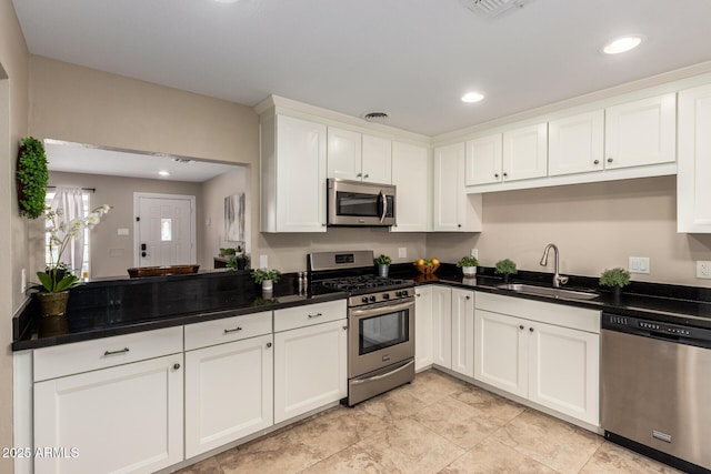 8155 E Columbus Ave, Scottsdale, AZ 85251 - kitchen featuring appliances with stainless steel finishes, dark countertops, white cabinets, and recessed lighting