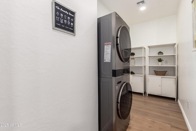 8155 E Columbus Ave, Scottsdale, AZ 85251 - washroom featuring stacked washing machine and dryer and light wood-style flooring