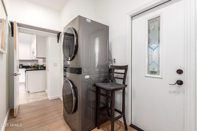 8155 E Columbus Ave, Scottsdale, AZ 85251 - laundry room with estacked washer and dryer and light wood-style floors