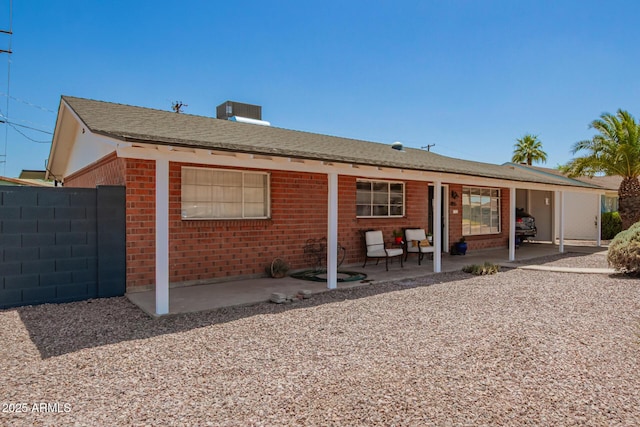 8155 E Columbus Ave, Scottsdale, AZ 85251 - back of house featuring a patio, brick siding, and roof with shingles