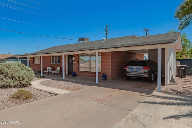 8155 E Columbus Ave, Scottsdale, AZ 85251 - single story home featuring concrete driveway, brick siding, a carport, and a shingled roof