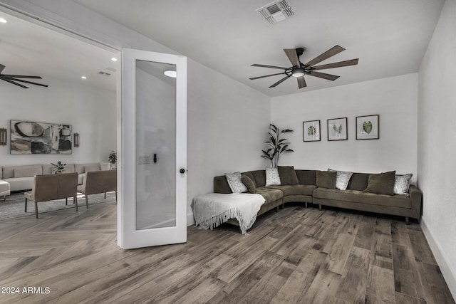 living room featuring hardwood / wood-style floors and ceiling fan