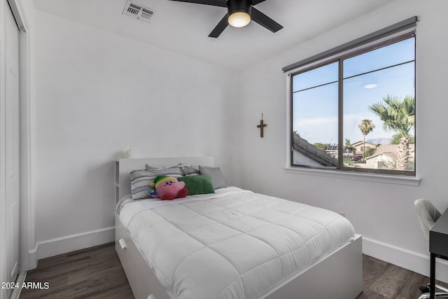 bedroom with dark hardwood / wood-style flooring and ceiling fan