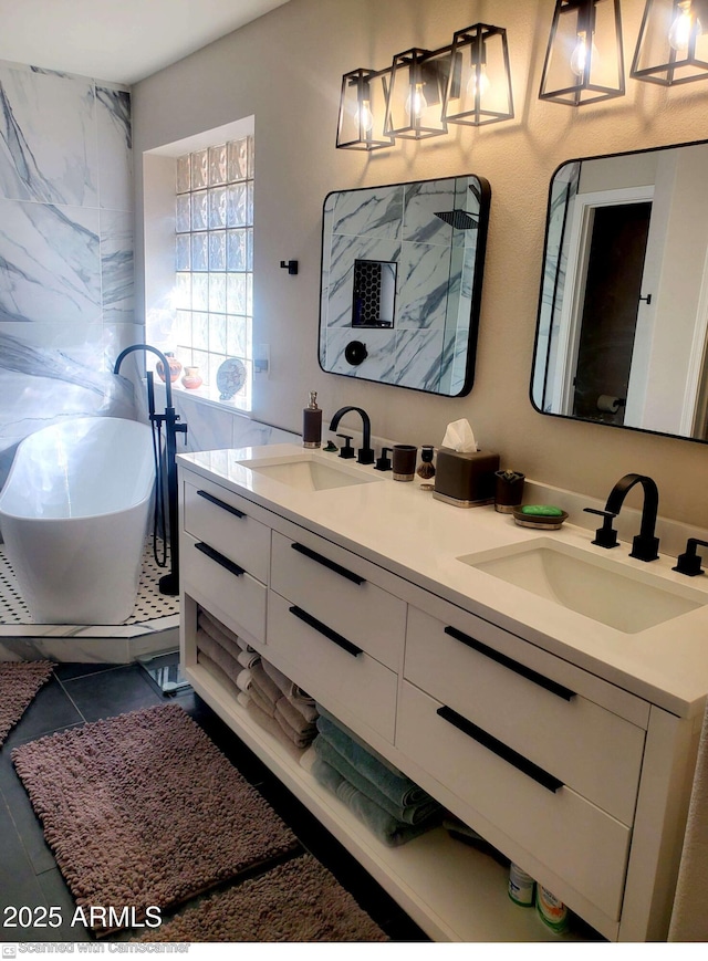 bathroom with vanity, tile patterned flooring, and a bathtub