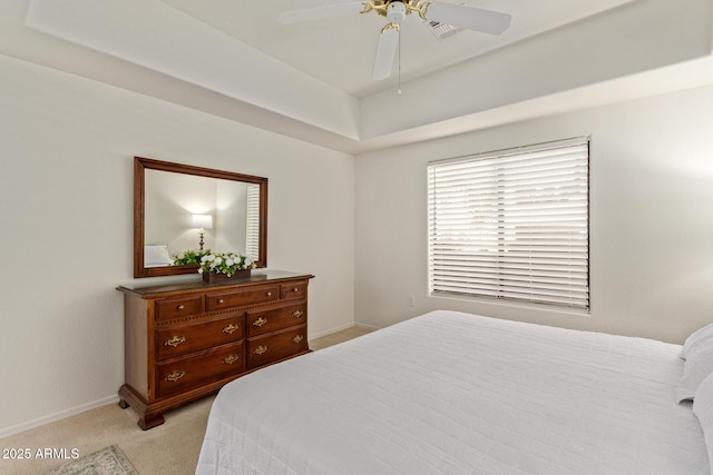 bedroom with baseboards, ceiling fan, light colored carpet, and visible vents