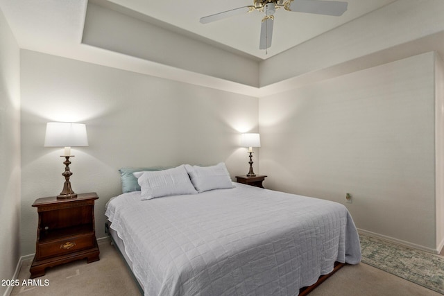 carpeted bedroom featuring baseboards and a ceiling fan