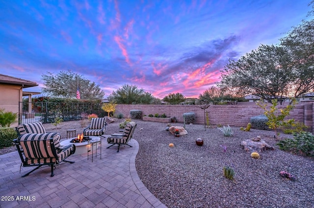 patio terrace at dusk with an outdoor fire pit