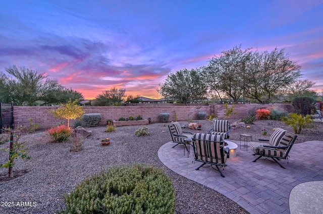 patio terrace at dusk featuring an outdoor fire pit