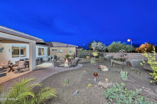 exterior space with an outdoor fire pit and a patio area