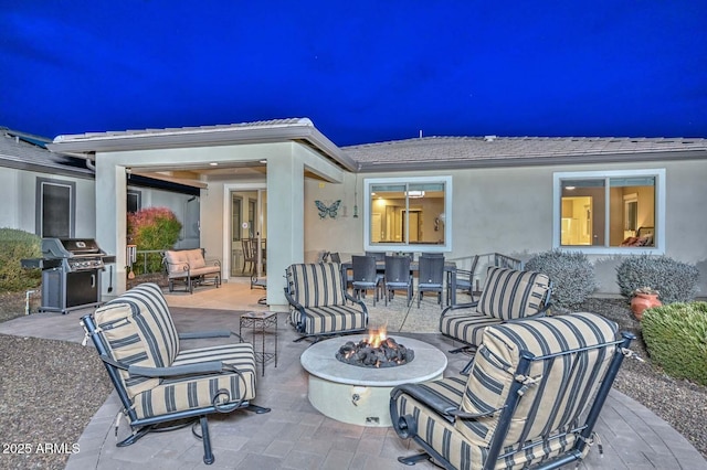 view of patio / terrace featuring a grill and a fire pit