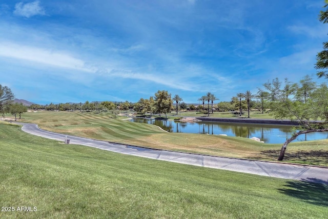 view of home's community featuring a lawn and a water view