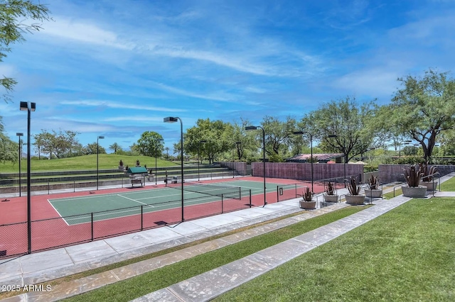 view of tennis court with a yard