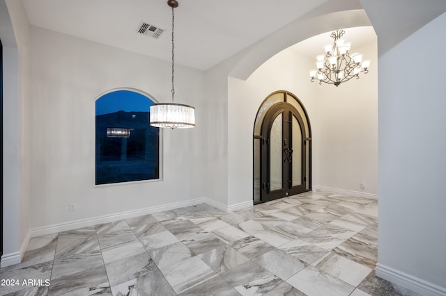 entryway with lofted ceiling and a notable chandelier