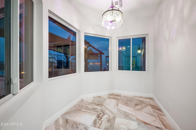 spare room with an inviting chandelier