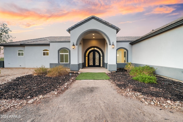 exterior entry at dusk with french doors