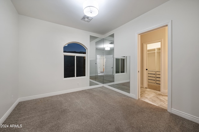 unfurnished bedroom featuring a closet and carpet flooring