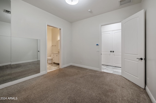 unfurnished bedroom with connected bathroom, a closet, and light colored carpet