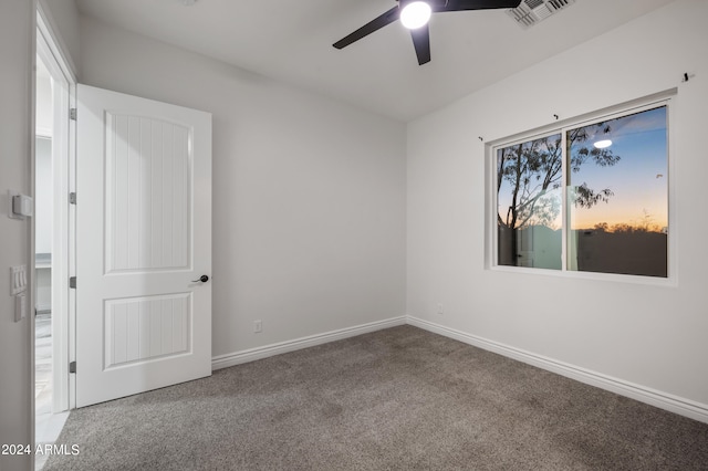 unfurnished room with carpet floors and ceiling fan