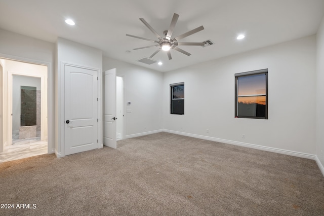 spare room featuring carpet floors and ceiling fan