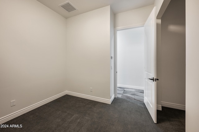 interior space featuring dark colored carpet