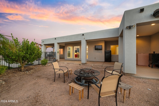 rear view of house with a patio area and an outdoor fire pit