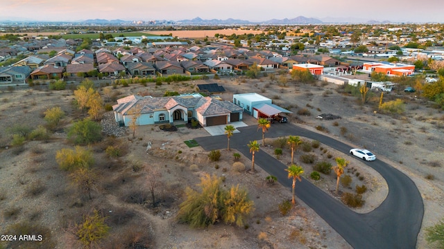 aerial view at dusk featuring a mountain view