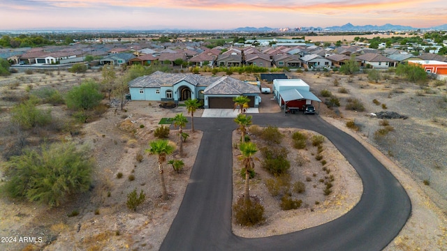 aerial view at dusk featuring a mountain view