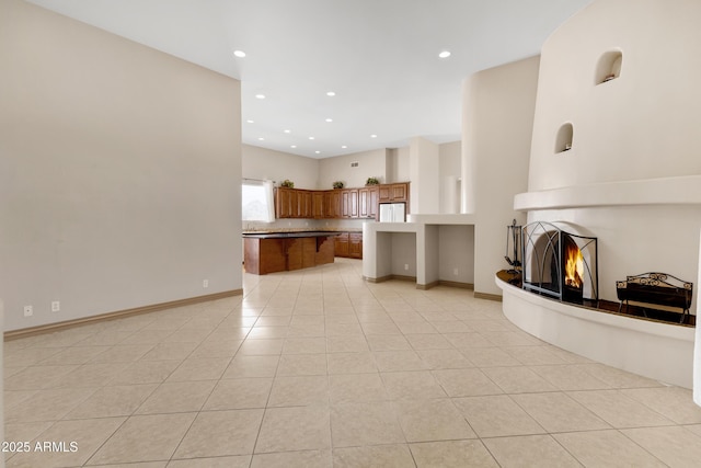 11266 W Calle Con Queso, Casa Grande, AZ 85194 - unfurnished living room with a warm lit fireplace, light tile patterned floors, and recessed lighting