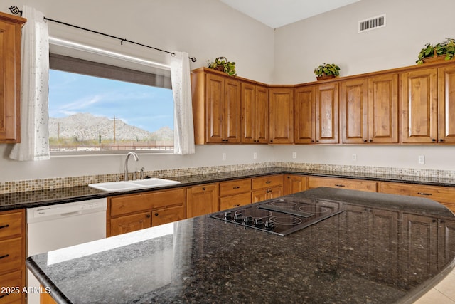11266 W Calle Con Queso, Casa Grande, AZ 85194 - kitchen with a sink, white dishwasher, brown cabinets, a center island, and black electric cooktop