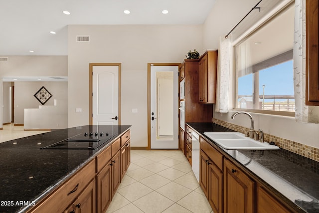 11266 W Calle Con Queso, Casa Grande, AZ 85194 - kitchen featuring a sink, white appliances, brown cabinetry, dark stone countertops, and recessed lighting